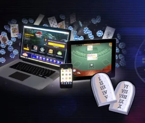 a laptop and phone with cards and dice